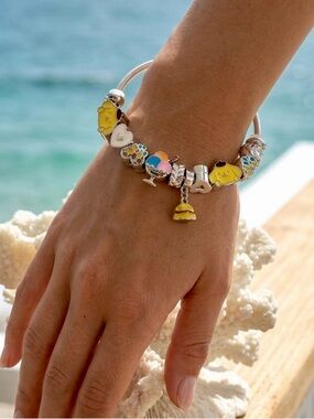 Whimsical silver cuff bangle bracelet with assorted color charms